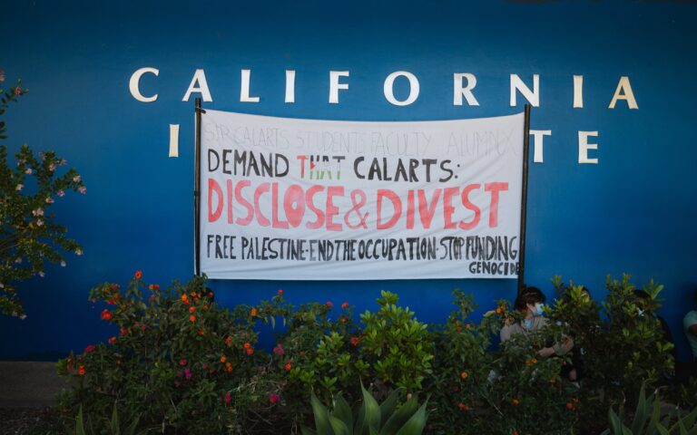 Banner posted at the blue wall as part of our 12 day and night Demonstration photo by Rafael Hernandez
